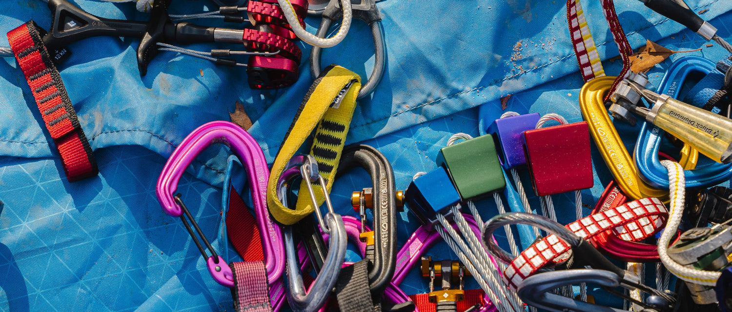 Climbing gear scatttered on a tarp.