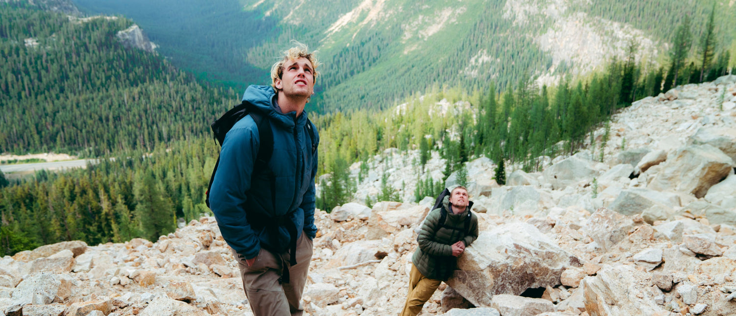 Two climbers look up at the wall.