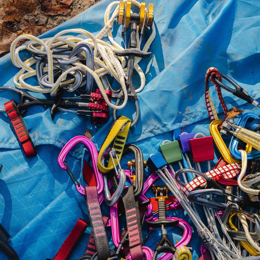 Climbing gear strewn on a tarp.