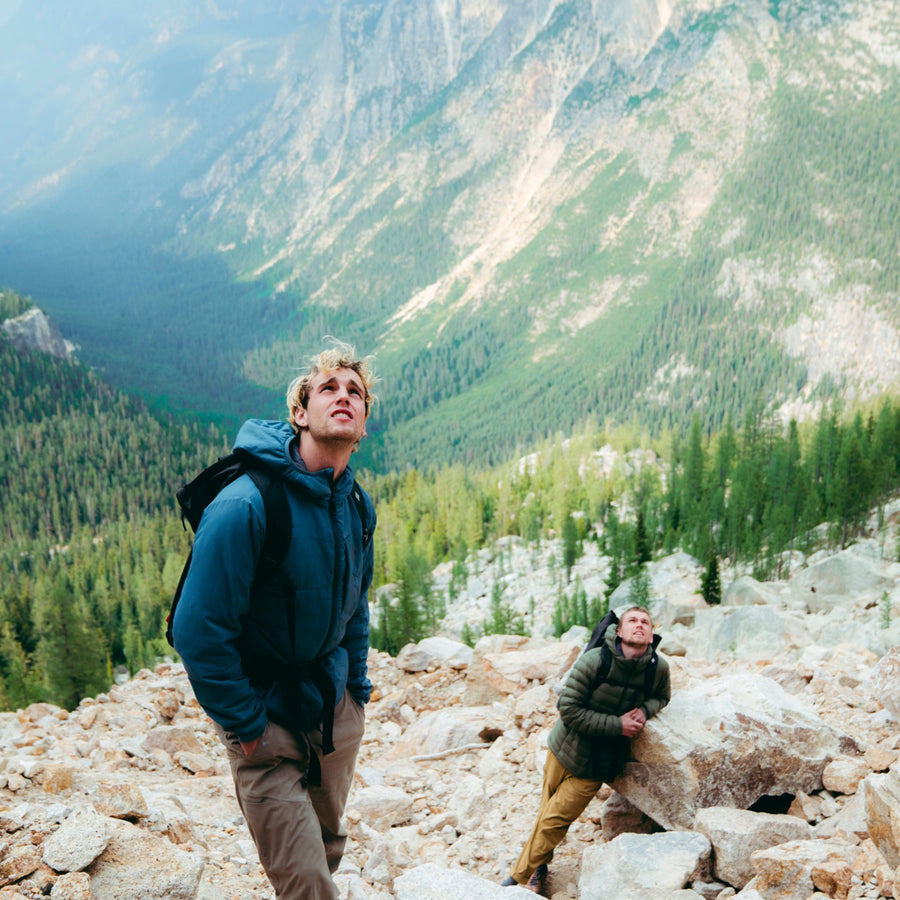 Two climbers look up at the wall.