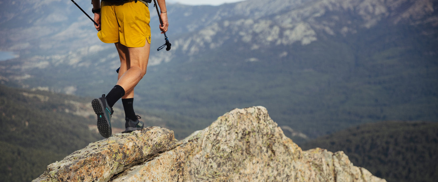 A man walks on a mountain ridgeline