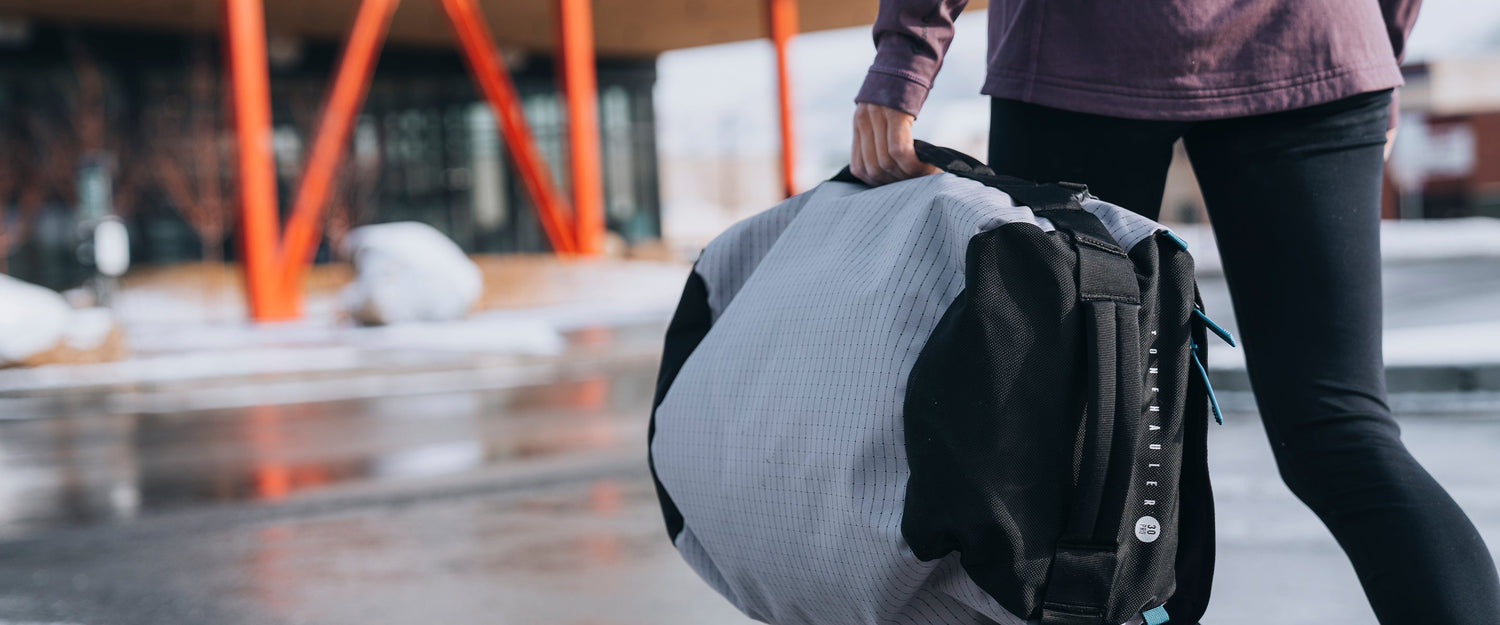A climber carrying a stonehauler duffel