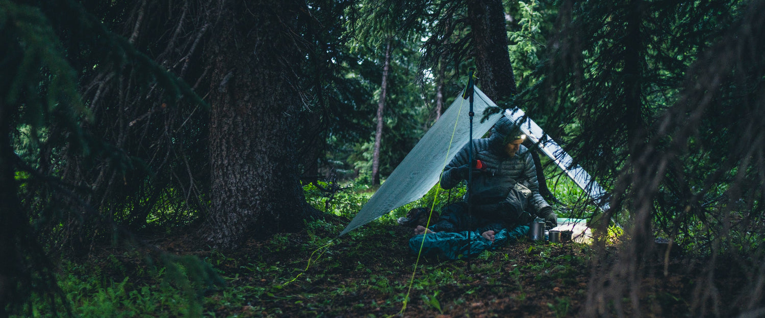 BD athlete Joe Grant adjusts his pack in a tent