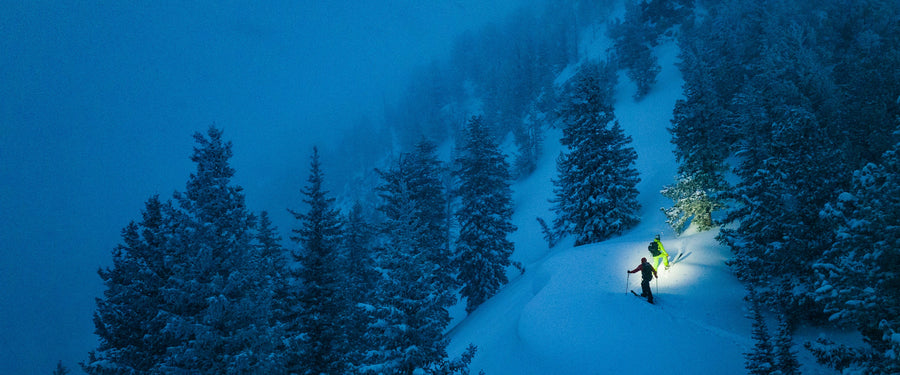 Two skiers skin up on a dawn patrol mission 