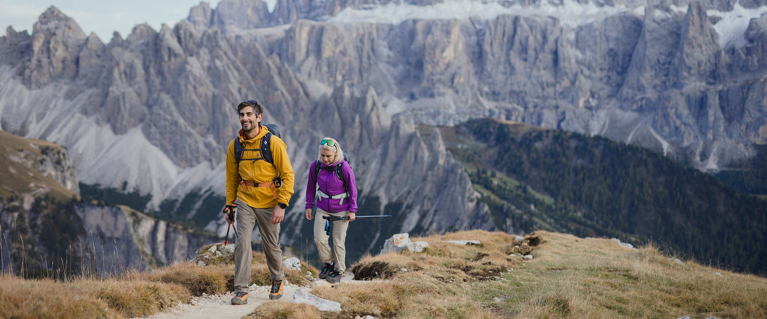 A man and woman hiking in the Dolomites