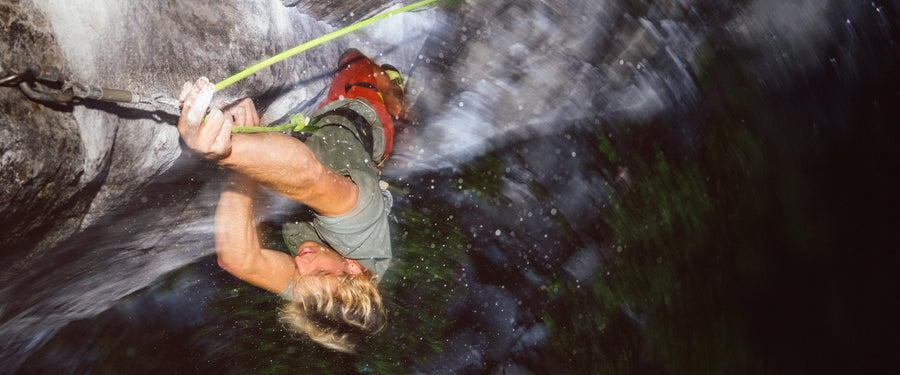 A man clipping a quickdraw in Mazama, WA