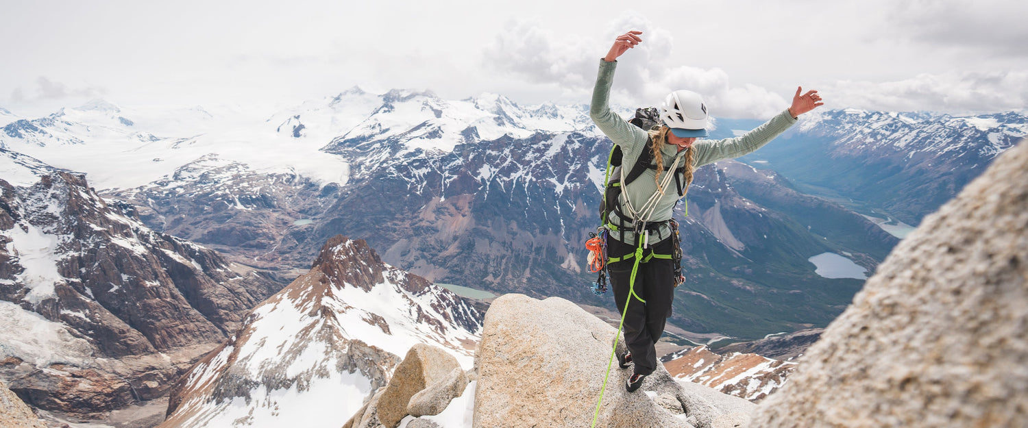 A climber balances on a ridge in Pattagonia