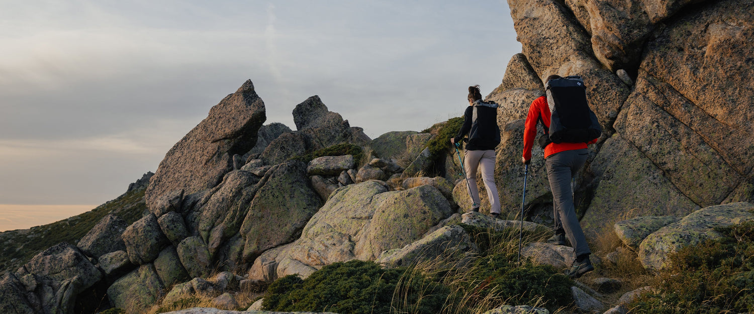 Two hikers wearing betalight packs in Corsica, France