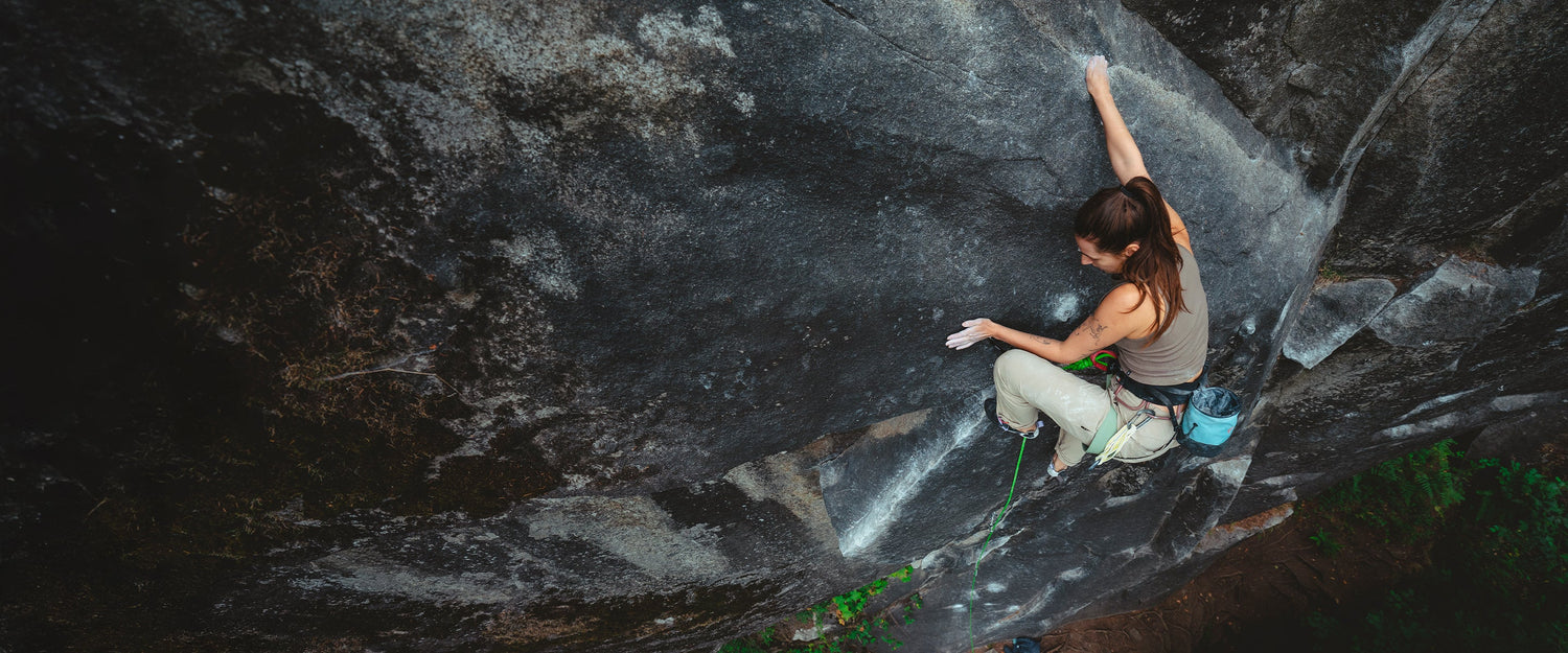 A climber palms the cliff while lead climbing in Mazama, WA