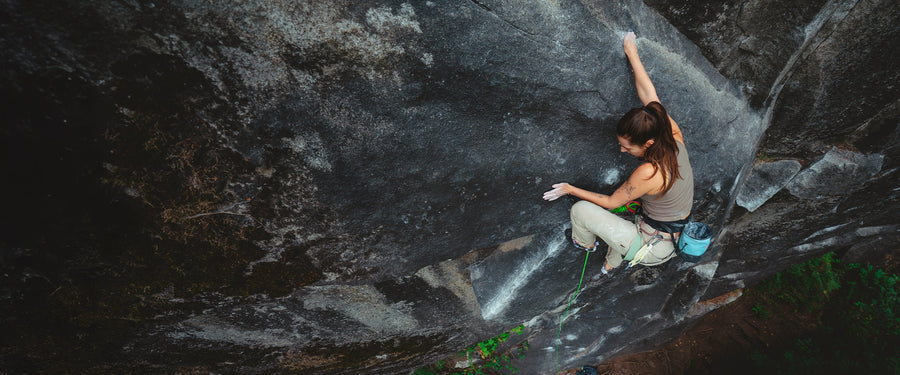 A climber palms the cliff while lead climbing in Mazama, WA
