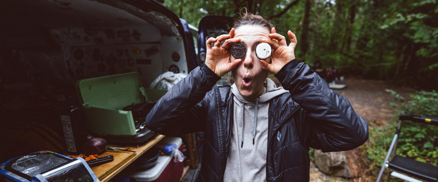 A woman holds oreos over her eyes