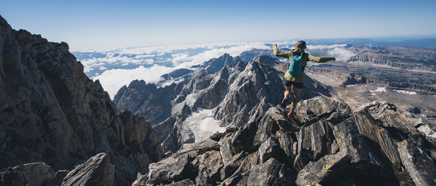 BD athlete Kelly Halpin running on a ridge in the Teton Range. 