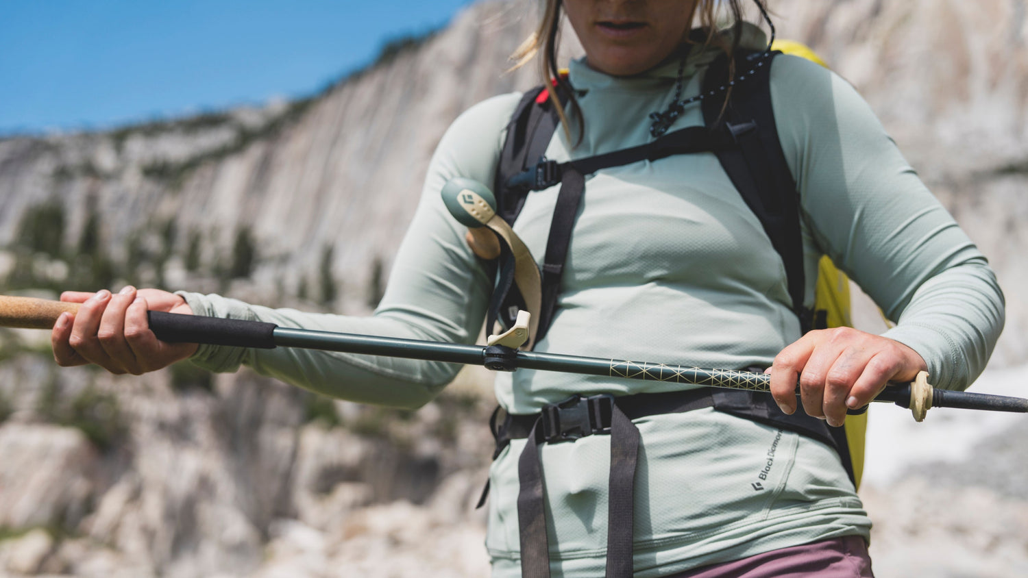 A hiker adjusts the flicklock on their Black Diamond trekking pole. 