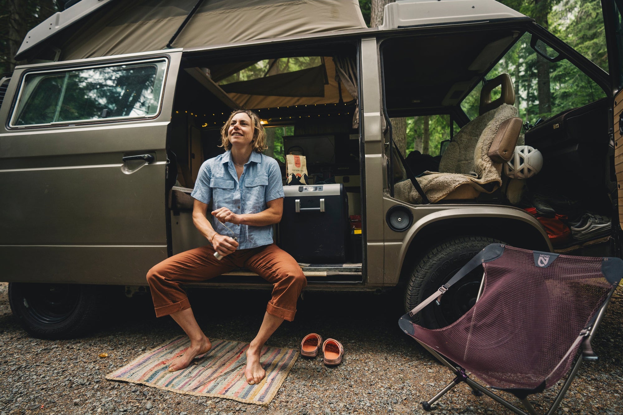A climber in a van prepping coffee for a day of sending.
