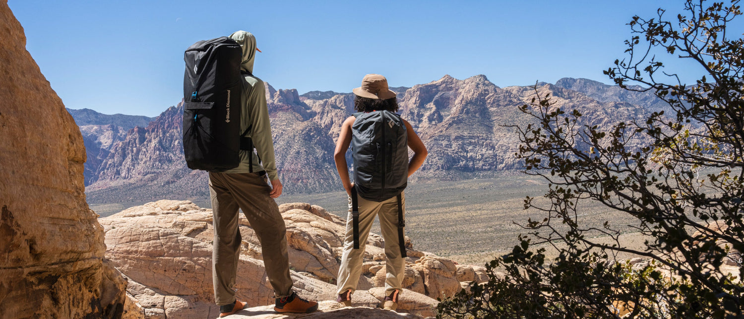 Climbers enjoy the view from the crag in the desert. 