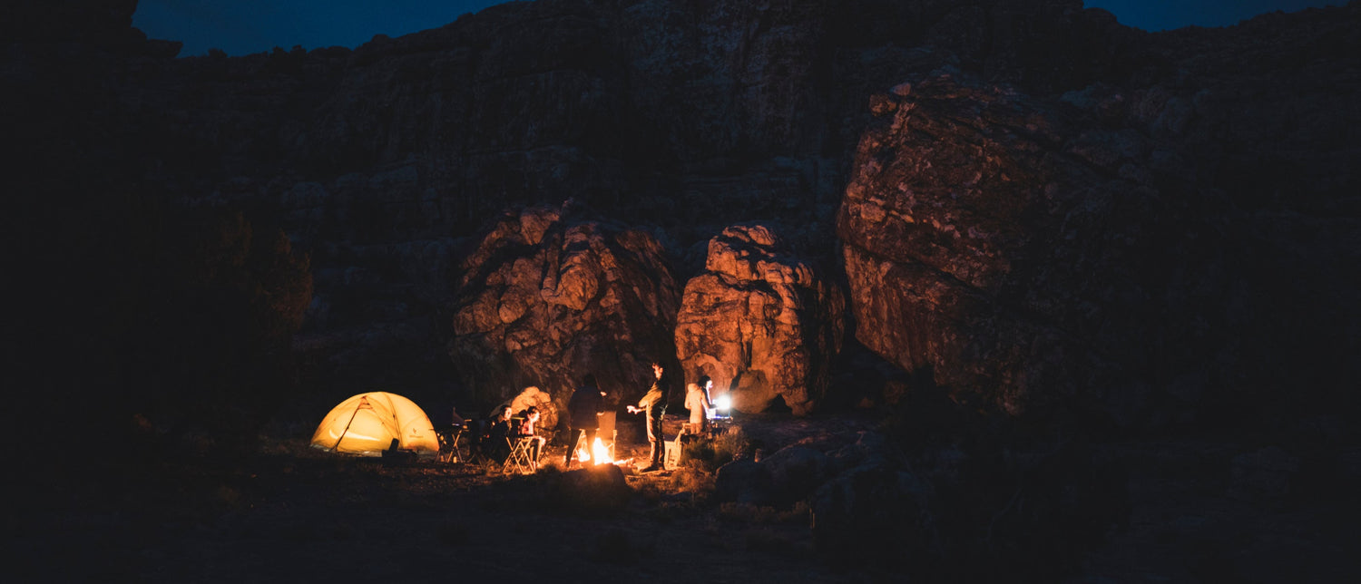 Campers at night illuminated by BD lights. 
