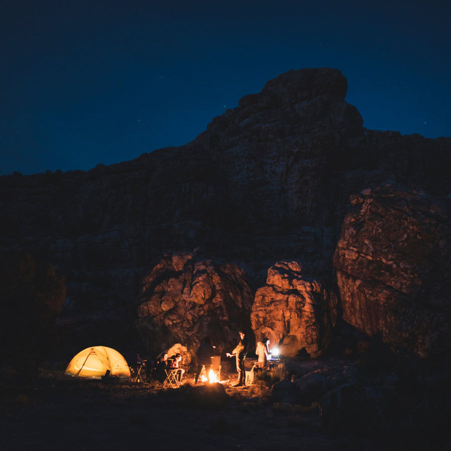 Campers at night illuminated by Black Diamond lanterns. 